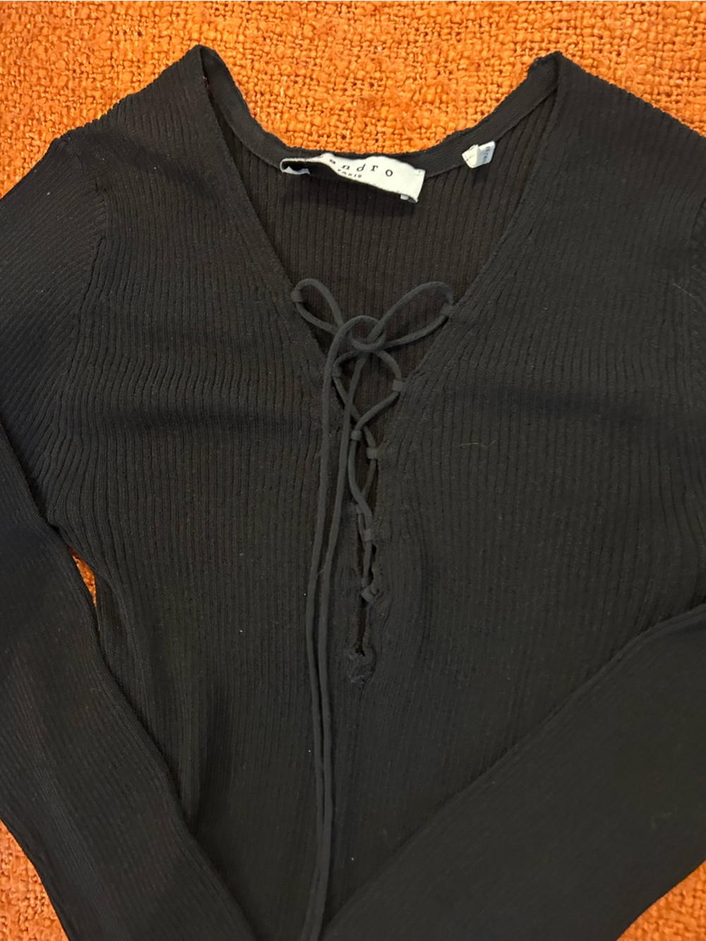 Sandro Ribbe’s jersey long sleeve v-neck top with front tie lace up closure.